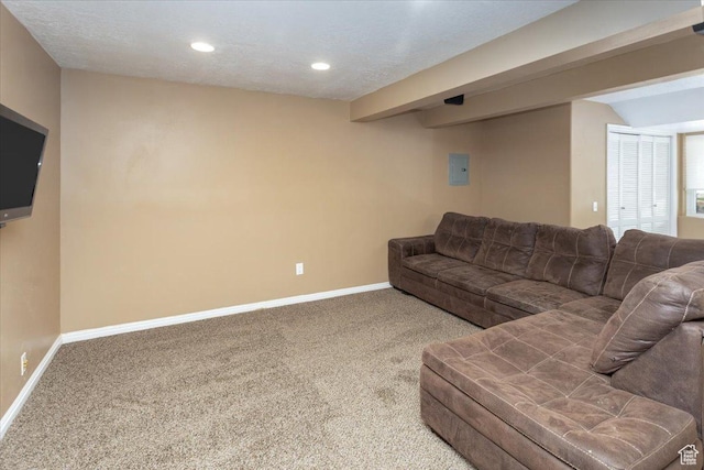 carpeted living area with baseboards and recessed lighting