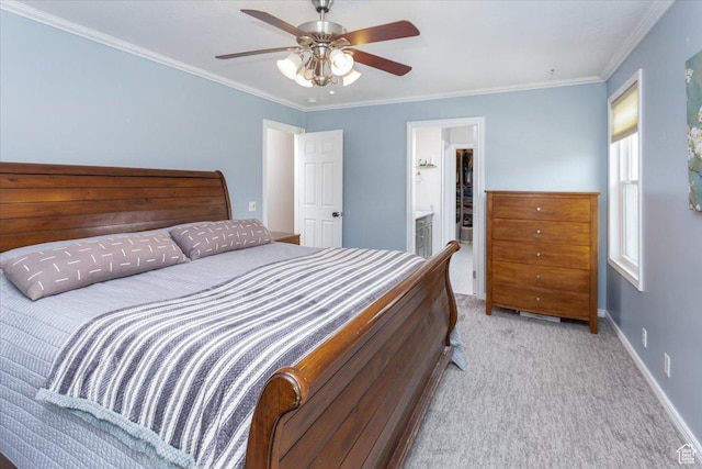carpeted bedroom featuring ensuite bath, a ceiling fan, baseboards, and crown molding