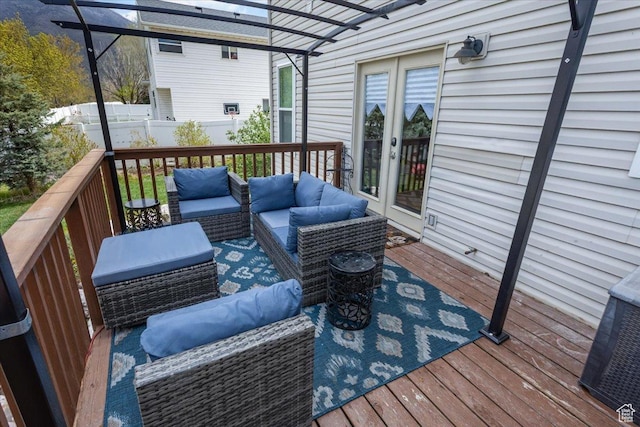 wooden deck with fence, an outdoor hangout area, and french doors