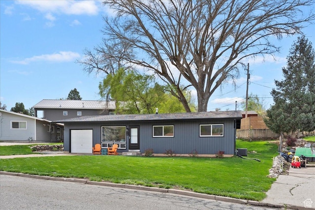 3315 Meadow Dr, Ogden, UT 84403 - view of front facade with central air condition unit, an attached garage, driveway, and a front lawn