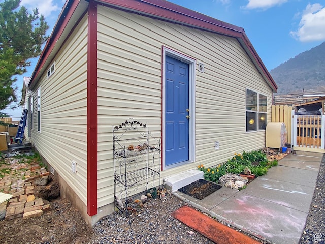 view of outbuilding with fence, entry steps, and a mountain view