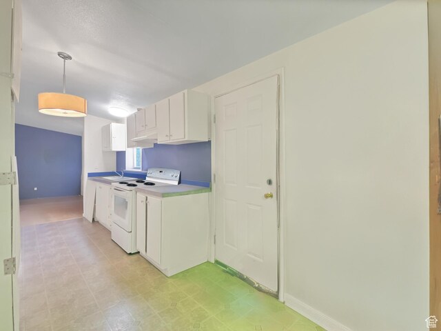 kitchen featuring white cabinets, baseboards, white electric range, pendant lighting, and light floors