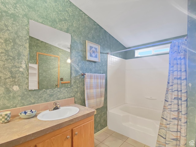 bathroom with wallpapered walls, lofted ceiling, shower / bath combo with shower curtain, and tile patterned floors