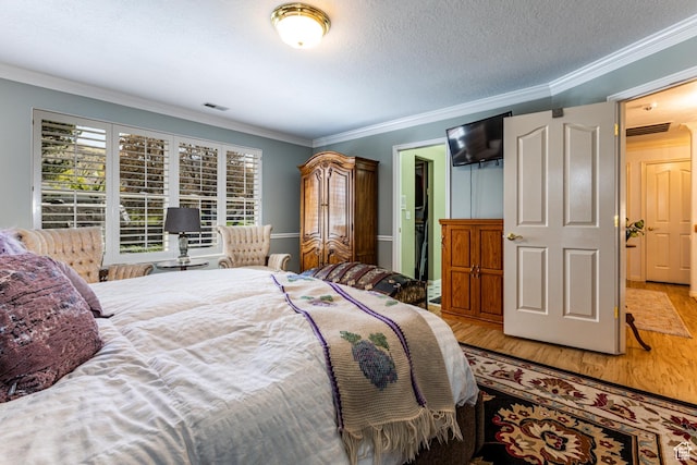 637 S Pine Meadow Ln, Tooele, UT 84074 - bedroom featuring a textured ceiling, wood finished floors, visible vents, and crown molding
