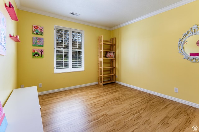 637 S Pine Meadow Ln, Tooele, UT 84074 - spare room with visible vents, baseboards, wood finished floors, and ornamental molding