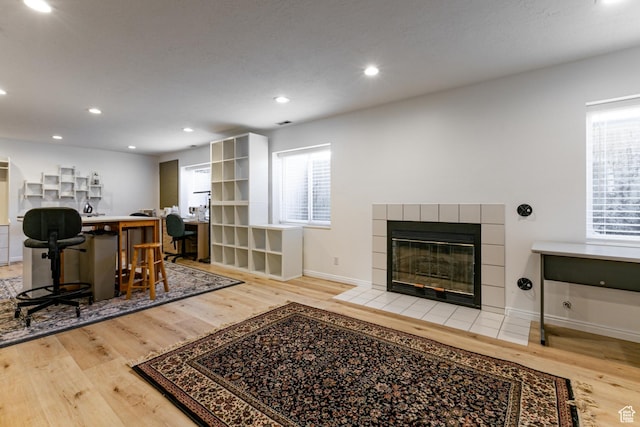 637 S Pine Meadow Ln, Tooele, UT 84074 - living room featuring baseboards, recessed lighting, wood finished floors, and a tiled fireplace