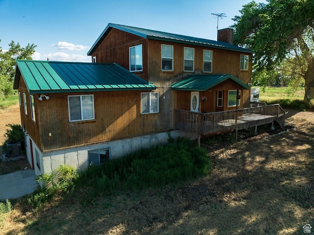 7413 W 7250 S, Myton, UT 84052 - back of property featuring a metal roof, a standing seam roof, a deck, and a chimney