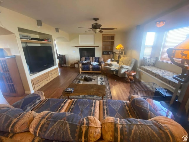 7413 W 7250 S, Myton, UT 84052 - living room with baseboards, a ceiling fan, wood finished floors, and built in shelves