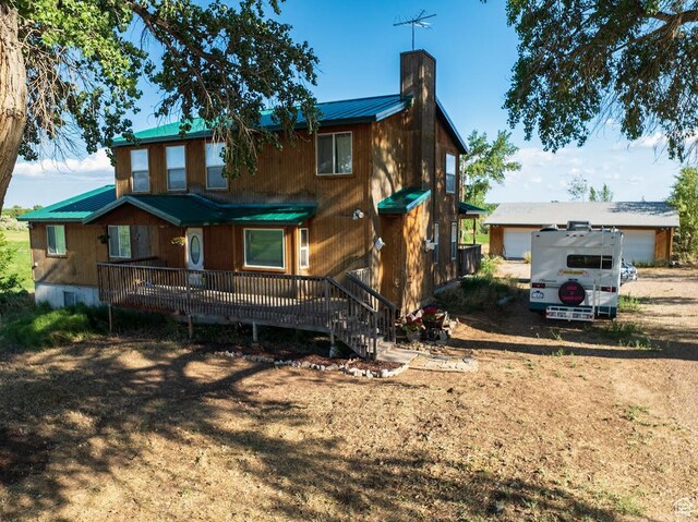 7413 W 7250 S, Myton, UT 84052 - rear view of property with a chimney, a metal roof, and a garage