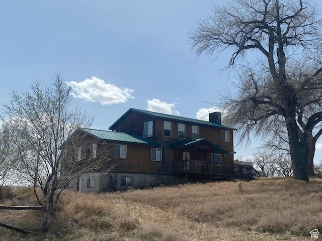 7413 W 7250 S, Myton, UT 84052 - rear view of property featuring a chimney and metal roof