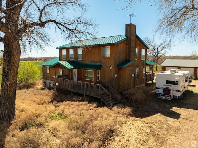7413 W 7250 S, Myton, UT 84052 - back of property with a porch, a standing seam roof, a chimney, and metal roof