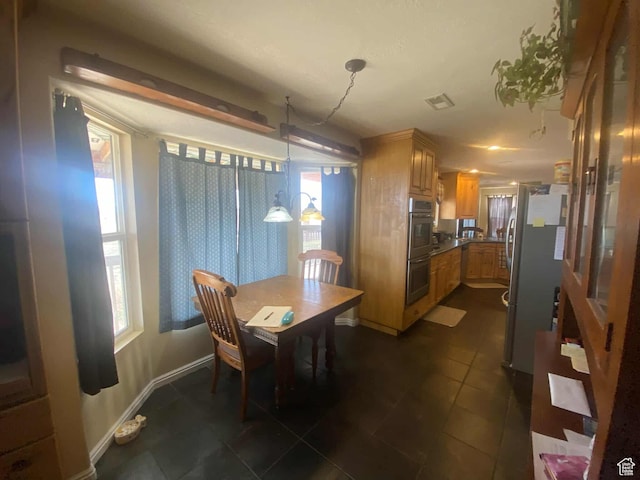 7413 W 7250 S, Myton, UT 84052 - dining area with visible vents, dark tile patterned flooring, and baseboards