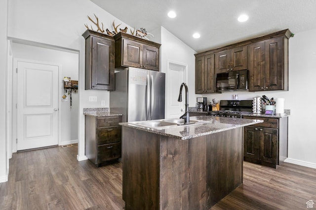 kitchen featuring a sink, black appliances, dark brown cabinetry, dark wood finished floors, and baseboards