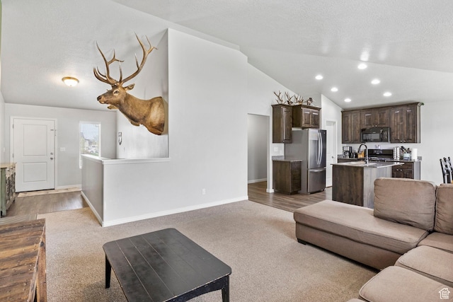 living area with light carpet, vaulted ceiling, baseboards, and recessed lighting