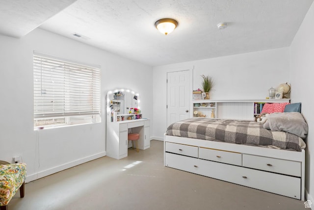 bedroom featuring baseboards, visible vents, and concrete floors