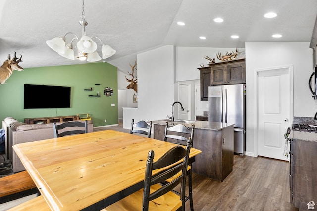 dining area featuring a textured ceiling, lofted ceiling, a notable chandelier, dark wood-style floors, and recessed lighting