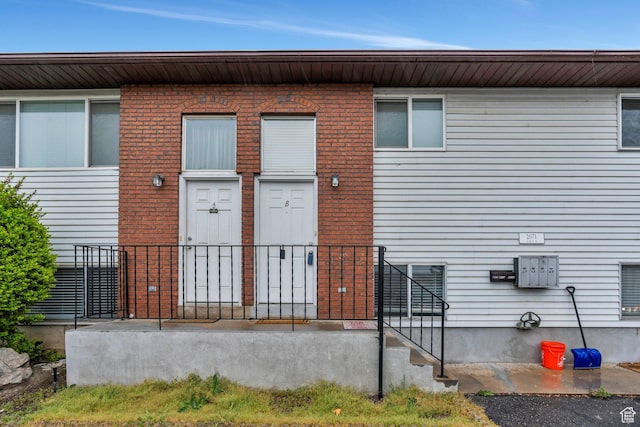 doorway to property with brick siding
