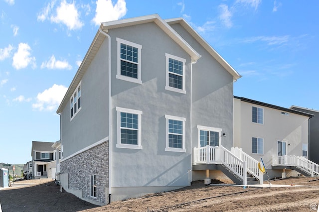 6622 W Spring Snow Ln, Herriman, UT 84096 - back of house featuring stucco siding and stone siding