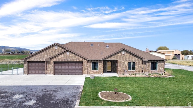 4990 W 12000 N, Tremonton, UT 84337 - ranch-style home with brick siding, driveway, a front yard, and a garage