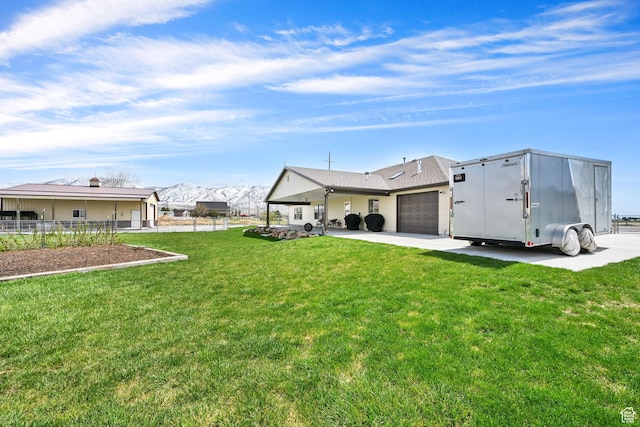 4990 W 12000 N, Tremonton, UT 84337 - rear view of property with a lawn, an attached garage, fence, and concrete driveway