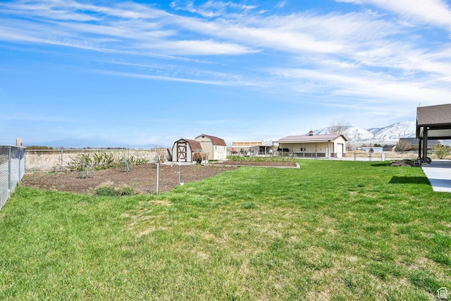 4990 W 12000 N, Tremonton, UT 84337 - view of yard featuring an outdoor structure, fence, a storage unit, and a mountain view