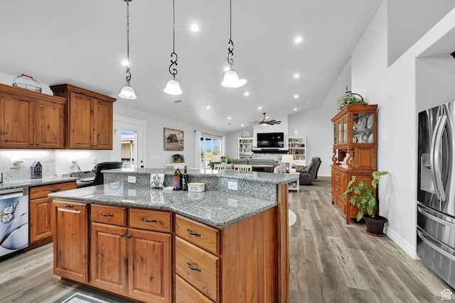 4990 W 12000 N, Tremonton, UT 84337 - kitchen featuring tasteful backsplash, stainless steel appliances, a fireplace, lofted ceiling, and a kitchen island