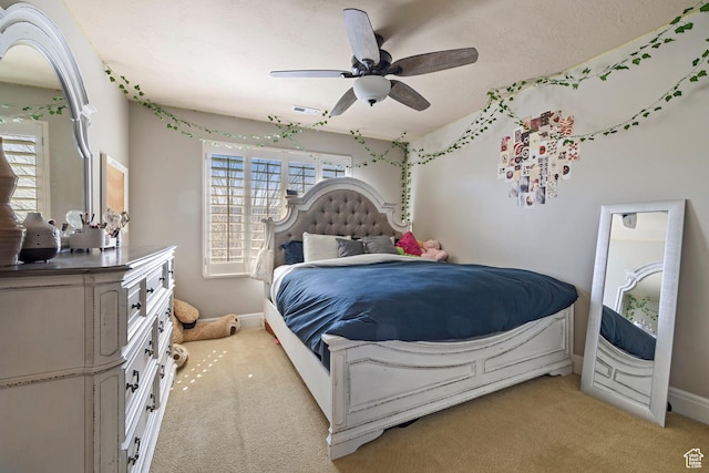 bedroom with baseboards, a ceiling fan, visible vents, and light colored carpet