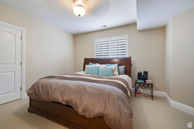 carpeted bedroom with visible vents and baseboards