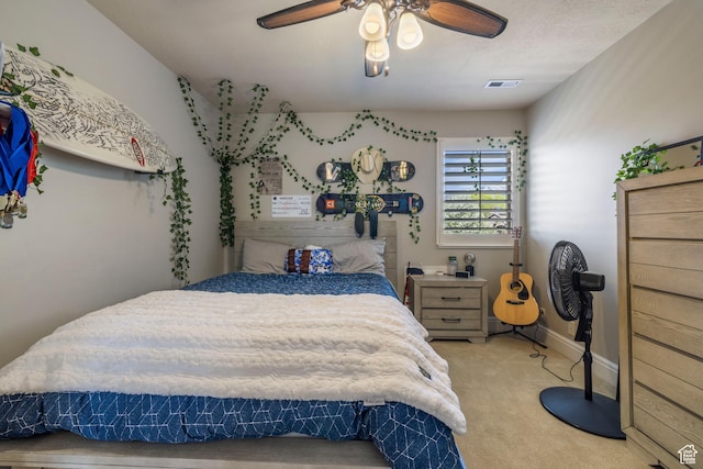bedroom with ceiling fan, baseboards, carpet flooring, and visible vents