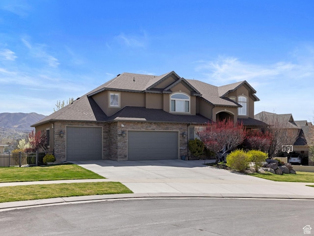 view of front of house featuring driveway, an attached garage, fence, a front yard, and stucco siding
