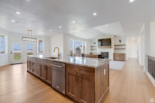 1993 S 5000 W, Taylor, UT 84401 - kitchen with a stone fireplace, stainless steel dishwasher, a sink, light stone countertops, and a center island with sink