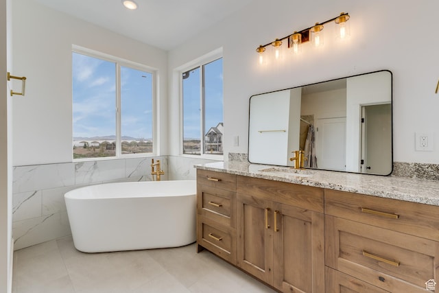 1993 S 5000 W, Taylor, UT 84401 - full bathroom featuring a wainscoted wall, tile patterned floors, vanity, tile walls, and a soaking tub