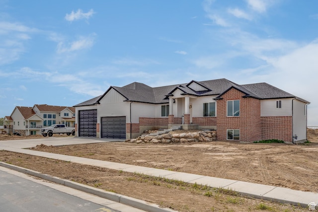1993 S 5000 W, Taylor, UT 84401 - view of front of home with roof with shingles, concrete driveway, an attached garage, brick siding, and a residential view