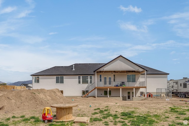 1993 S 5000 W, Taylor, UT 84401 - back of property with stairway, a ceiling fan, a deck, stucco siding, and roof with shingles