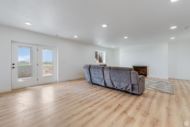 1993 S 5000 W, Taylor, UT 84401 - living area with recessed lighting, a warm lit fireplace, visible vents, light wood-style floors, and baseboards