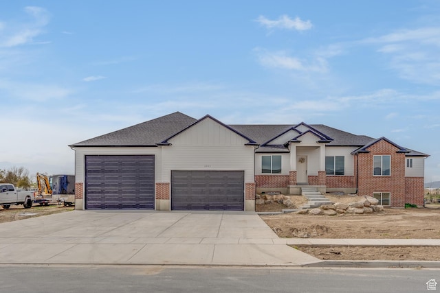 view of front of house with concrete driveway, an attached garage, and brick siding