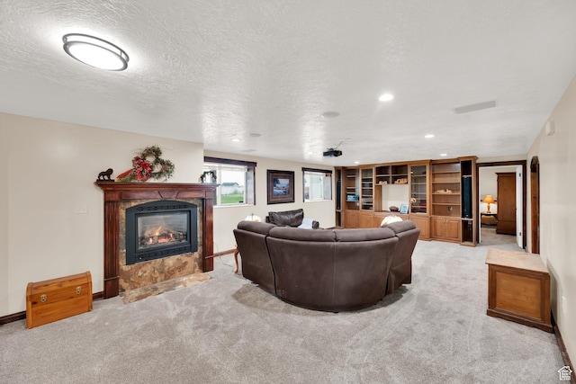 living area with a tile fireplace, visible vents, recessed lighting, and light carpet