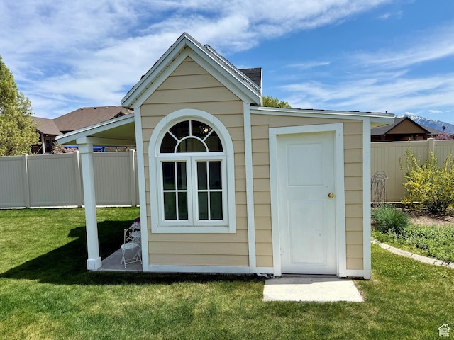 view of outbuilding with an outdoor structure and fence