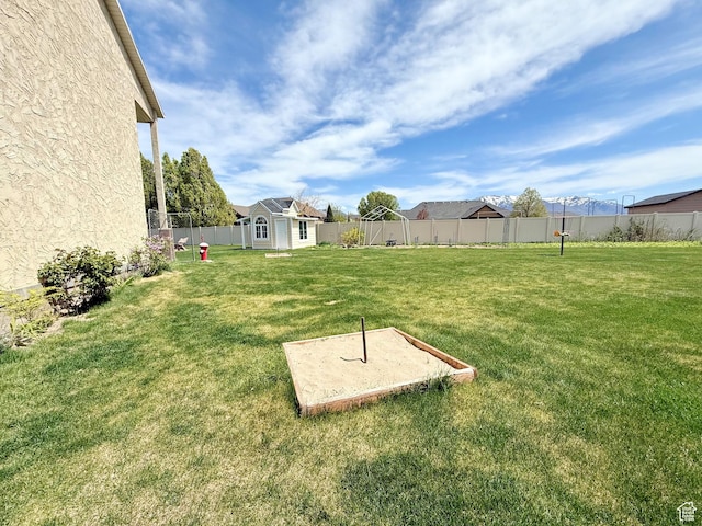 view of yard featuring a fenced backyard and an outbuilding