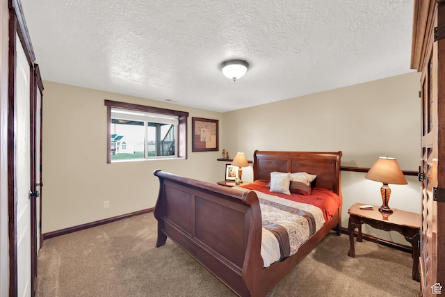 bedroom with a textured ceiling, baseboards, and light carpet