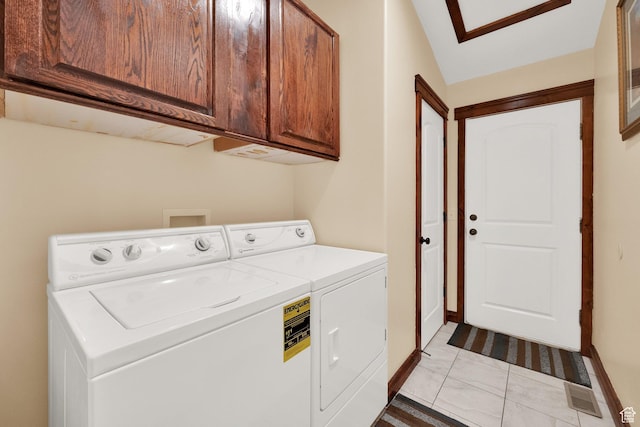 laundry area with separate washer and dryer and cabinet space