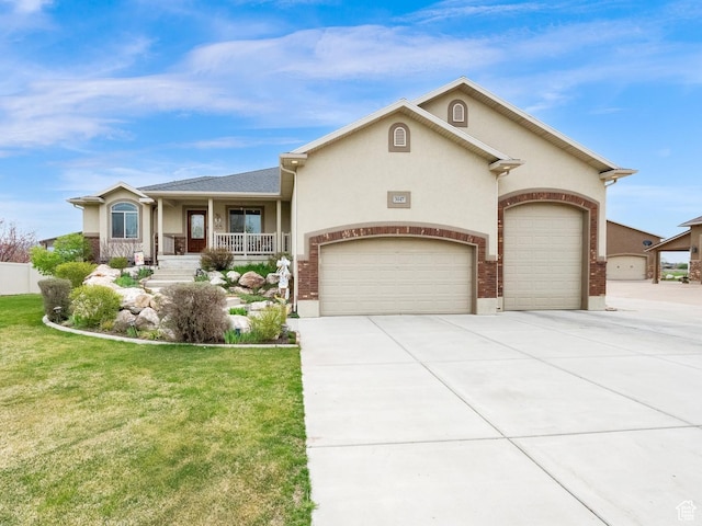 view of front of house with a front lawn, driveway, covered porch, a garage, and stucco siding
