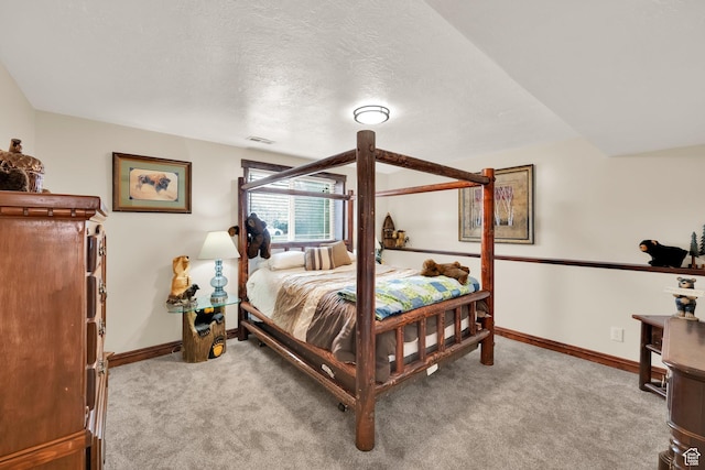 carpeted bedroom featuring baseboards, visible vents, and a textured ceiling