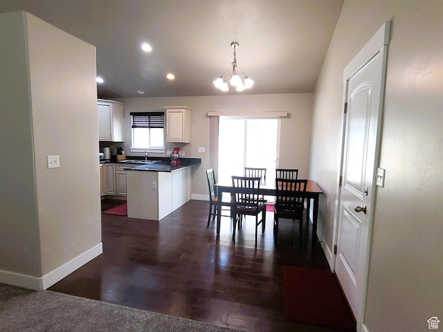 dining room featuring recessed lighting, dark wood-type flooring, baseboards, and a notable chandelier