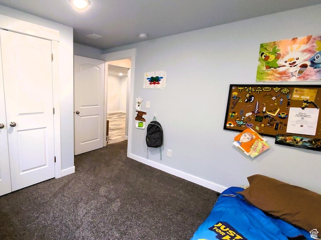 unfurnished bedroom featuring baseboards and dark carpet