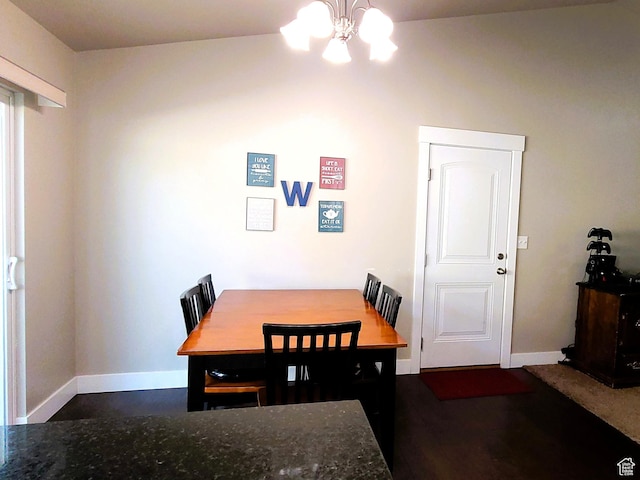 dining space featuring baseboards and an inviting chandelier