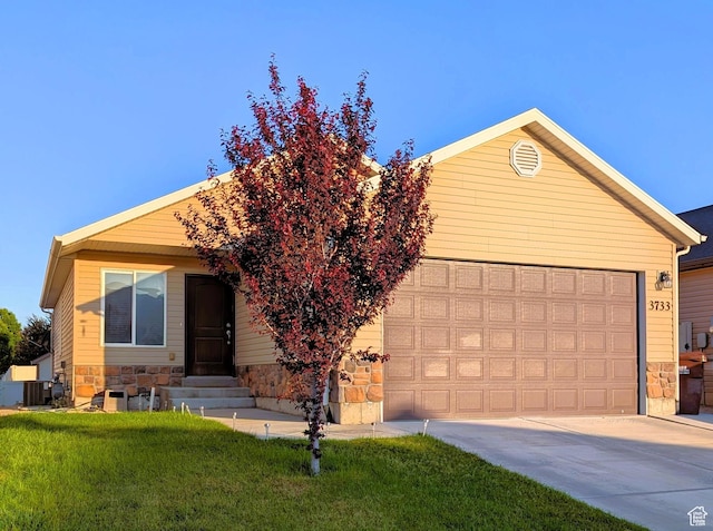 3733 N Bountiful Ln, Eagle Mountain, UT 84005 - ranch-style house featuring stone siding, driveway, entry steps, a garage, and a front yard