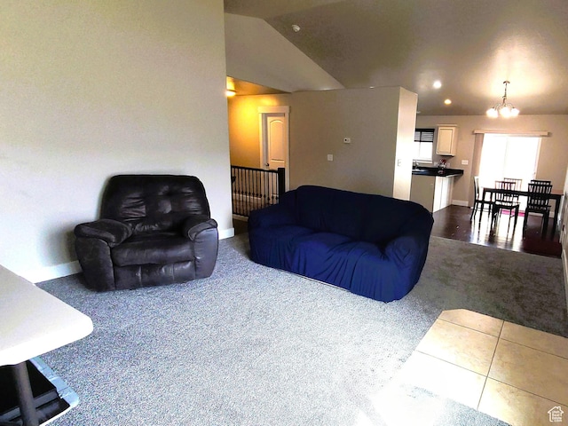 living room featuring recessed lighting, baseboards, dark carpet, and a notable chandelier