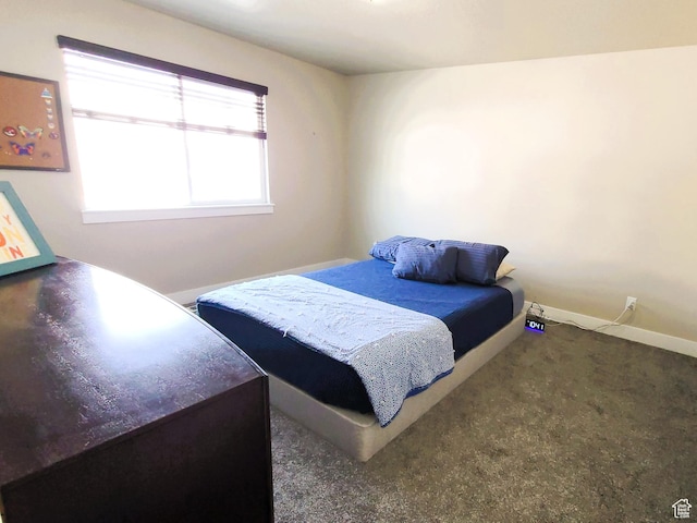 bedroom featuring carpet and baseboards