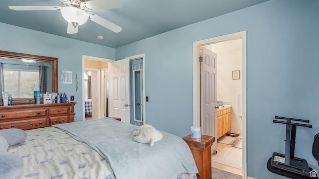 bedroom with connected bathroom, ceiling fan, baseboards, and a closet